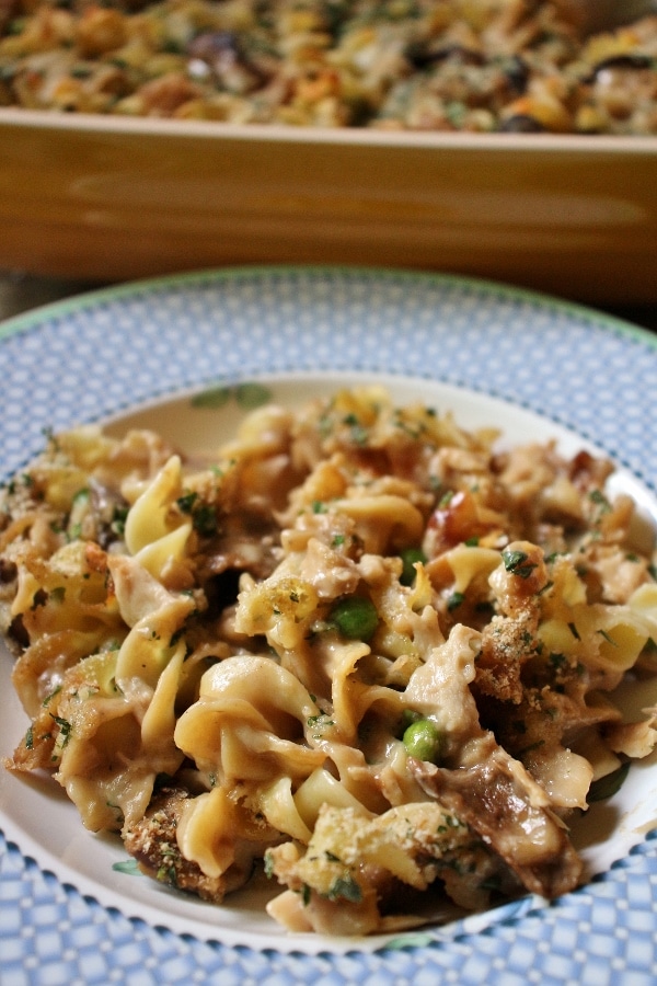 a plate of homemade tuna noodle casserole with mushrooms and peas