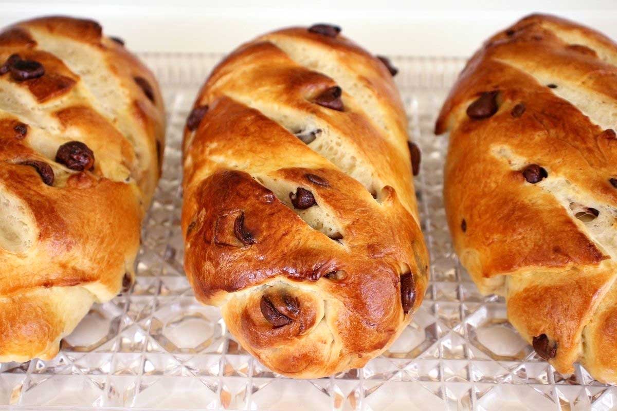 Three small loaves of Viennoise (Vienna bread) with chocolate chips.