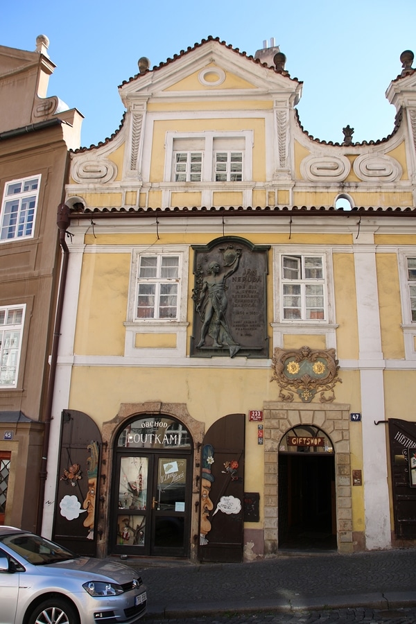 a yellow building with a metal plaque on the front