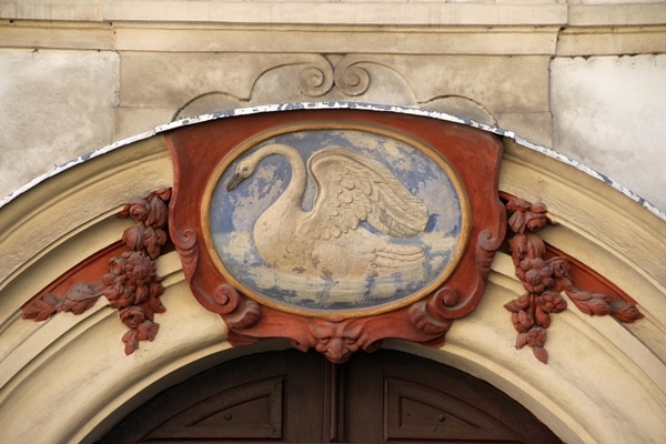 closeup of a swan emblem over a doorway