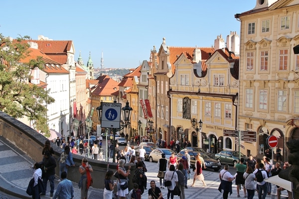 A group of people walking down a street in front of a building