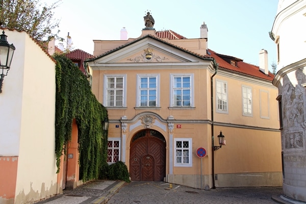 an peach building with a large wooden door