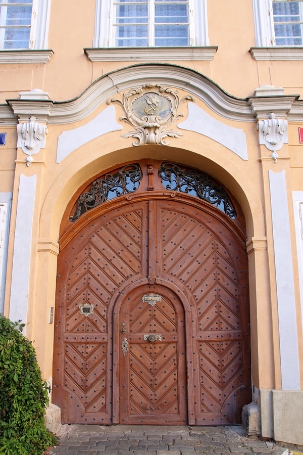 closeup of a peach building with a large wooden door