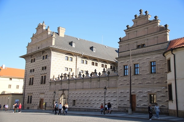 A group of people walking in front of a building