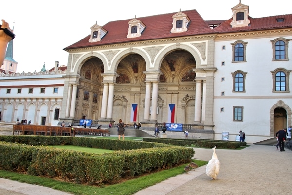 a large stone building with gardens in front