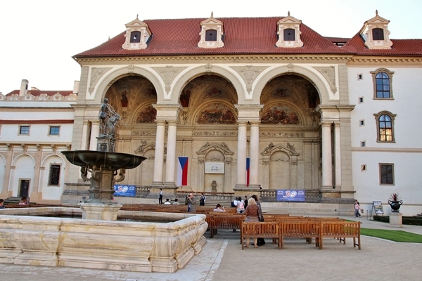 a large stone building with a fountain in front