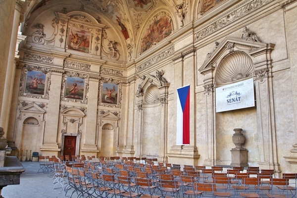 a large open air space with fresco ceilings and lots of chairs