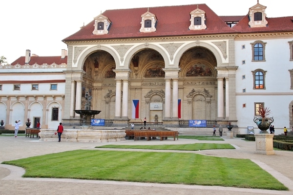 A large stone building with grass in front