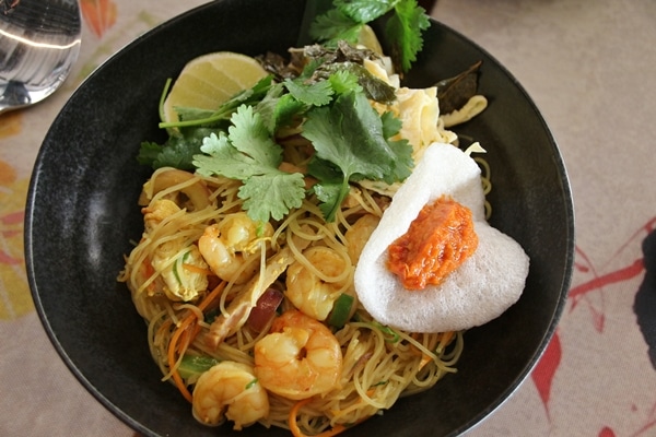 a bowl of noodles with shrimp and vegetables