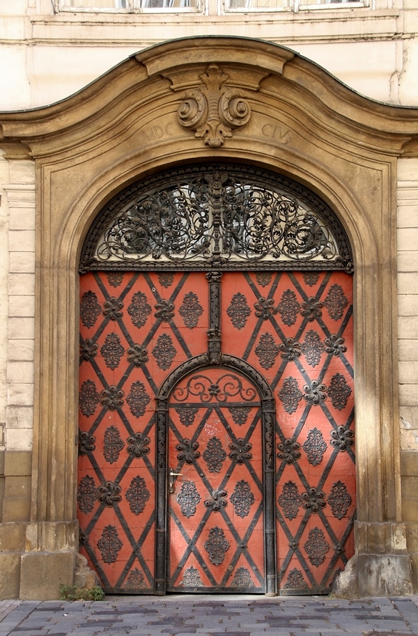 an elaborate red door with black detailing 