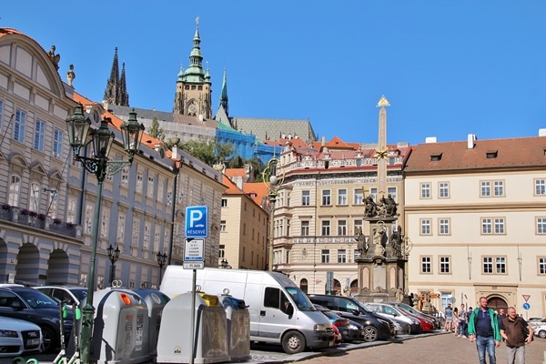 a city square with cars and big buildings