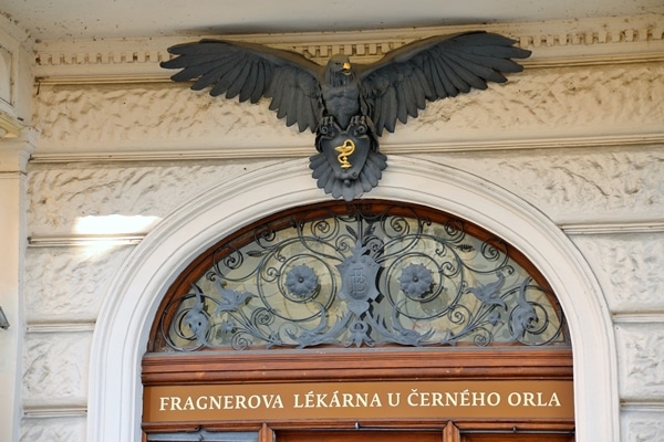 a black eagle statue over a doorway