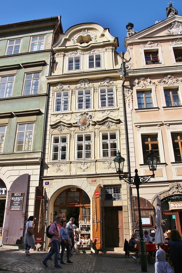 A group of people walking in front of a building