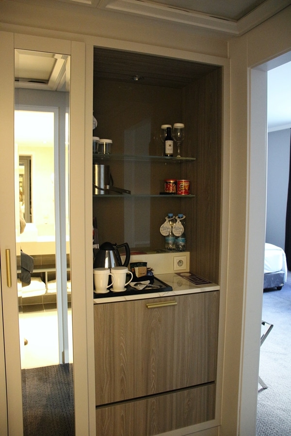 a coffee maker and mini fridge in a hotel room