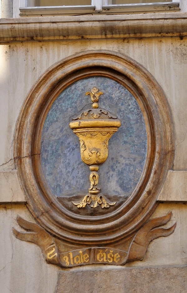 A gold chalice on a blue background