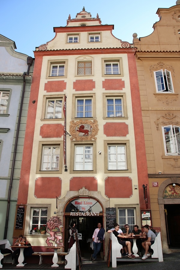 a tall building with an image of a red lion on the facade