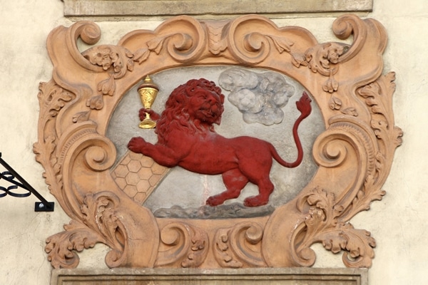 closeup of a red lion holding a gold chalice