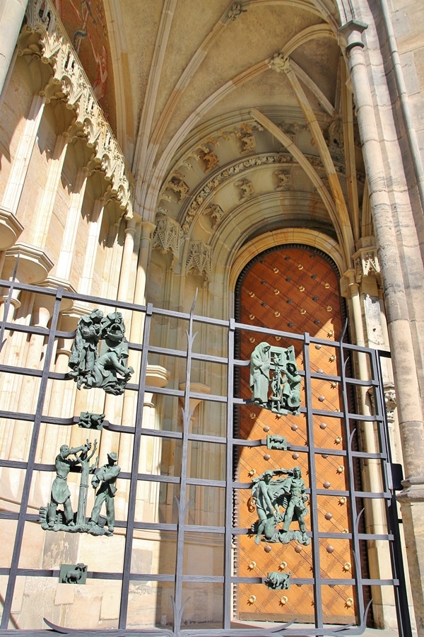 a gate in front of a large wooden door