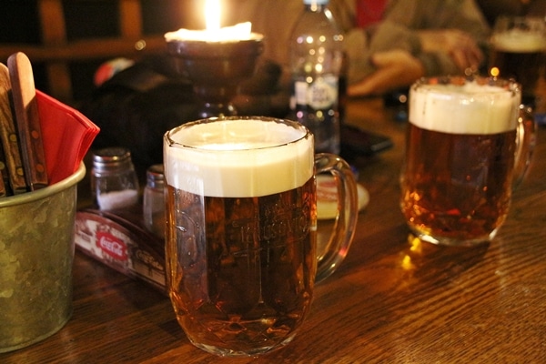 a glass of beer on a wooden table