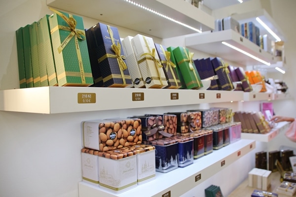 the interior of a chocolate shop with boxes of chocolate lined up