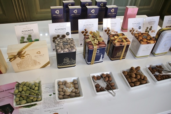 a sampling of chocolates in square plates on a counter