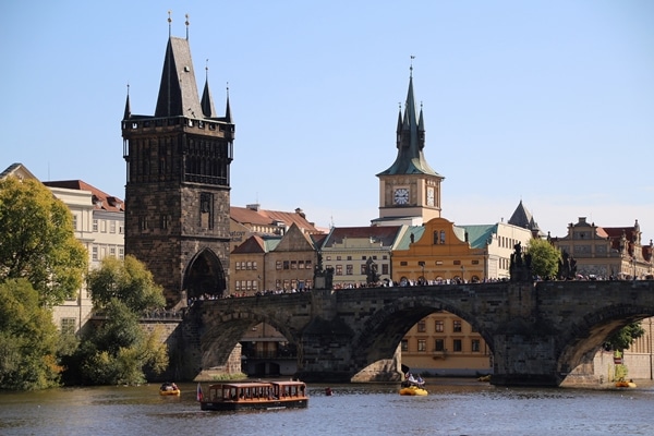 a stone bridge over a river with a tower at one end