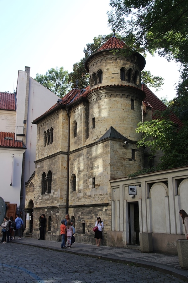 A group of people walking in front a building