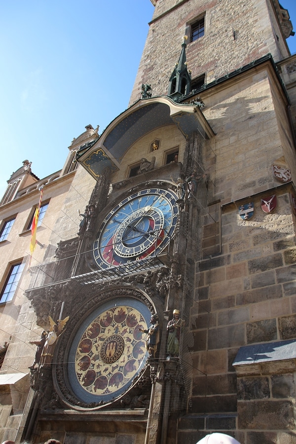 A large brick tower with a clock on the side of a building