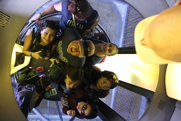 view of a group of people in an elevator, captured in a mirrored ceiling