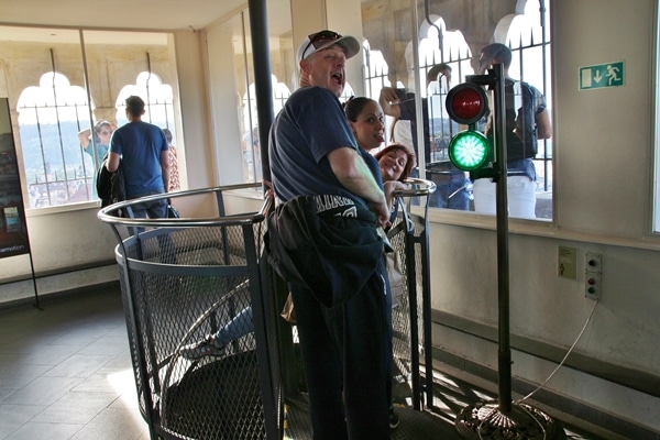 a group of people standing at the top of a staircase with a green light