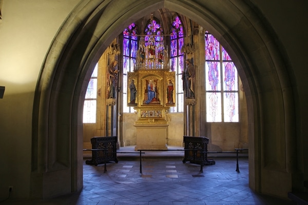 a small chapel interior with stained glass windows