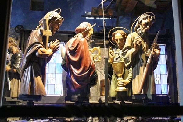 figurines of the Apostles behind a window