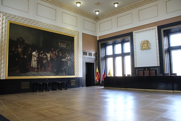 a large open room with a giant painting on one wall