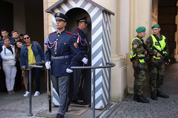 2 soldiers in blue uniforms in a changing of the guard ceremony