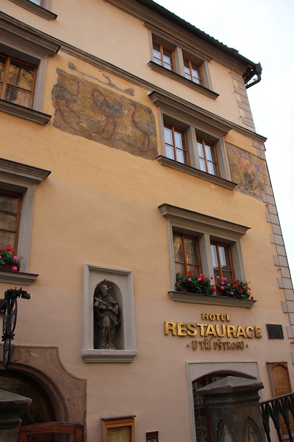 the exterior of a building with flowers in the windows