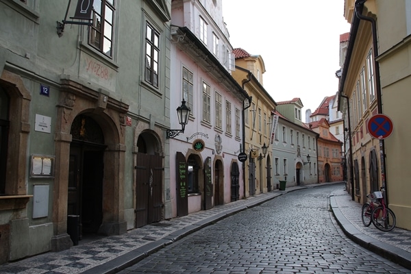 an empty cobblestone street with colorful buildings