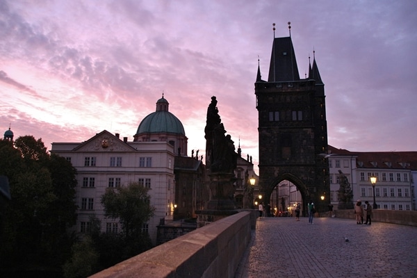 view of Charles Bridge and Old Town Bridge Tower at dawn