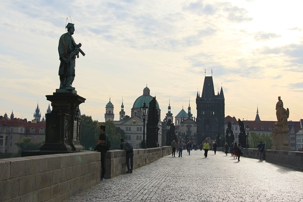 a morning view of mostly empty Charles Bridge in Prague