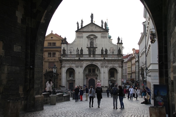 A group of people walking in front of a building