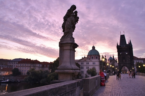 statue on Charles Bridge at dawn