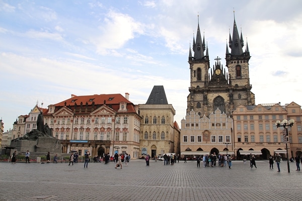 a mostly empty square in Prague with a large church