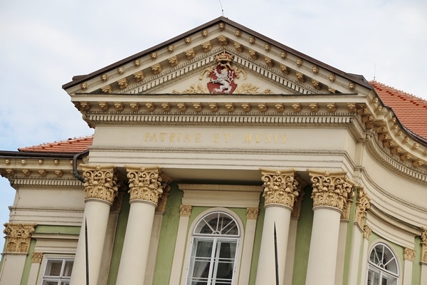 closeup of ornate detailing on a mint green and ivory building