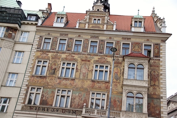 A large building with colorful fresco paintings on the exterior