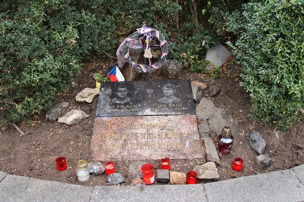 a small monument surrounded by red candles