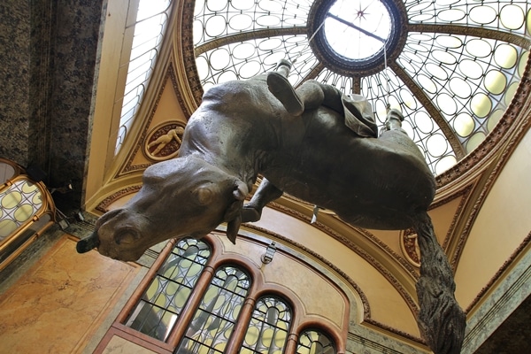 view looking up at a statue of a man sitting on an upside horse