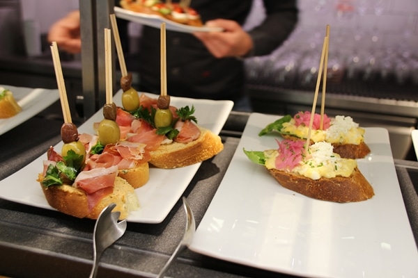 plates of food with skewers sticking out of them