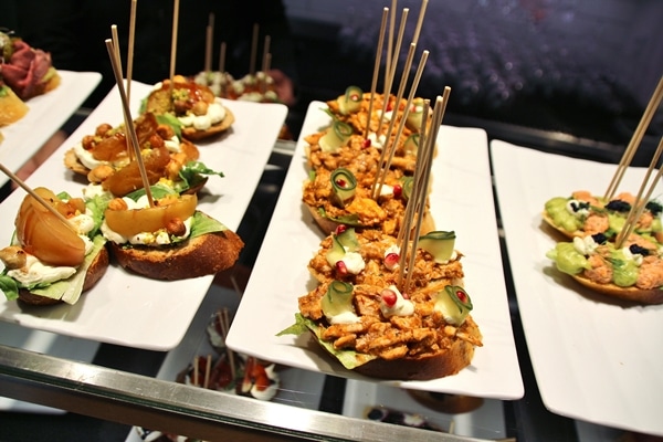 a close up of open-faced sandwiches with skewers in them