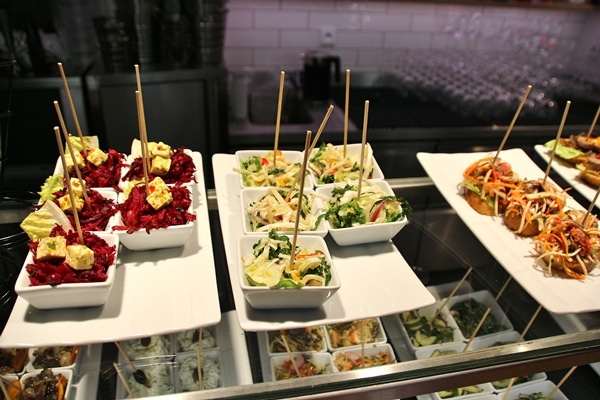 a buffet of small white dishes of food