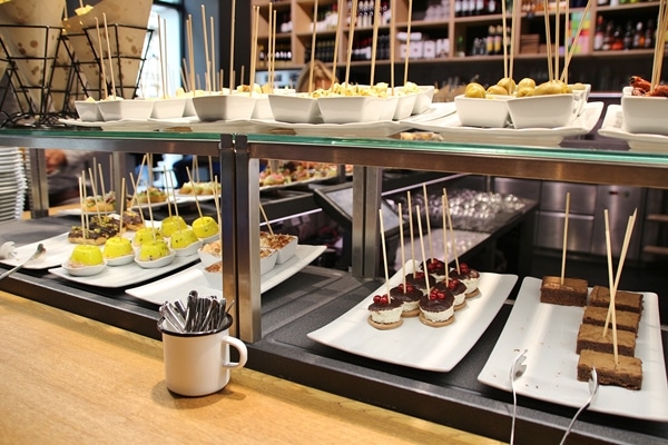 a buffet line with various foods on sticks