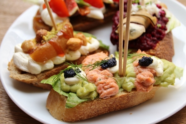 a closeup of open-faced sandwiches on a white plate